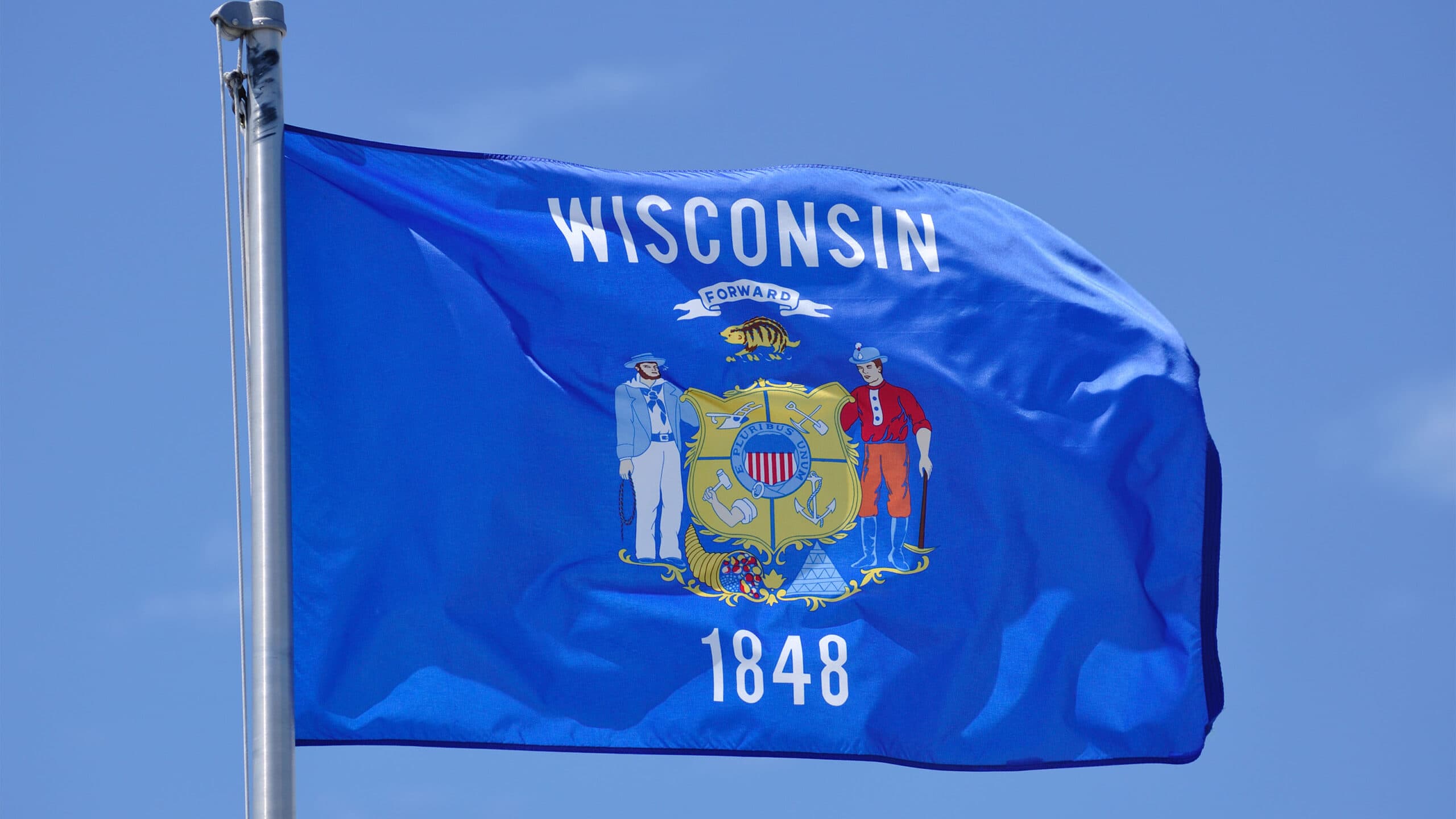 Wisconsin State Flag Against a Blue SKy